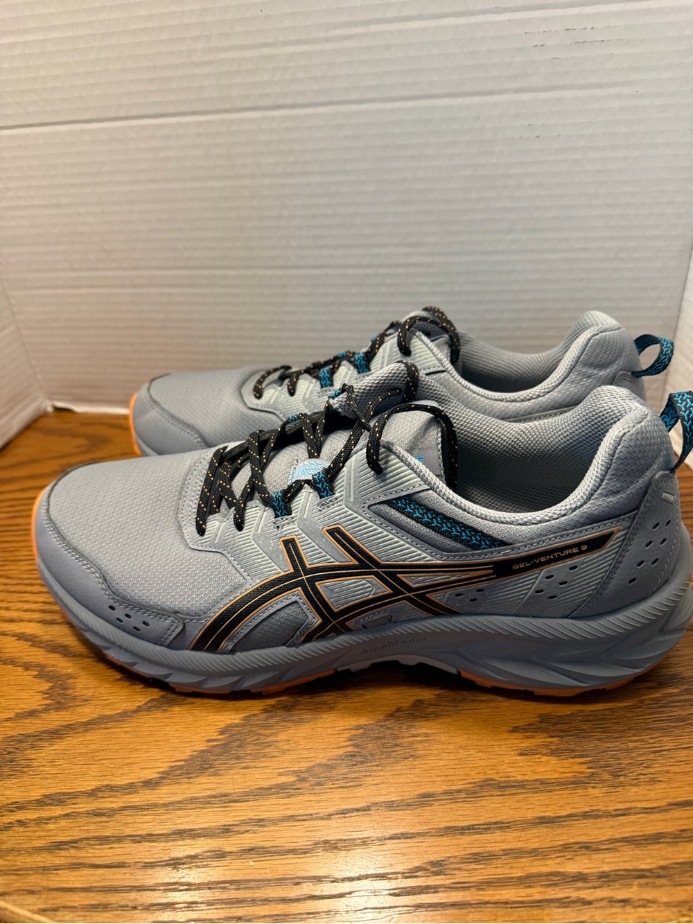 Asics Light Gray and Black Trail Running Shoes with Blue Accents